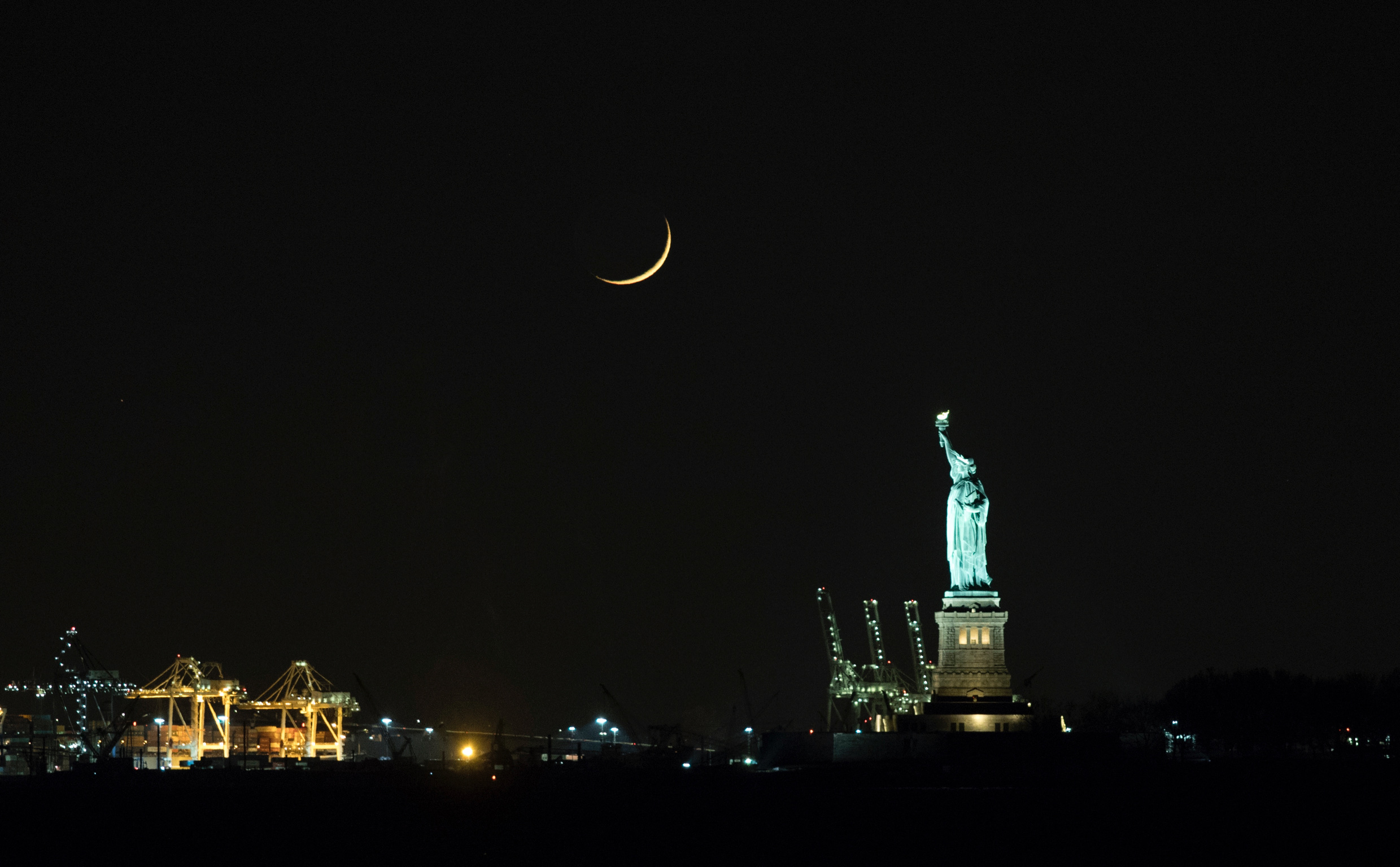 Crescent Moon over Statue of Liberty by John Bills